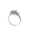 14K white gold three-stone engagement ring with round cut diamonds and pave set accents.