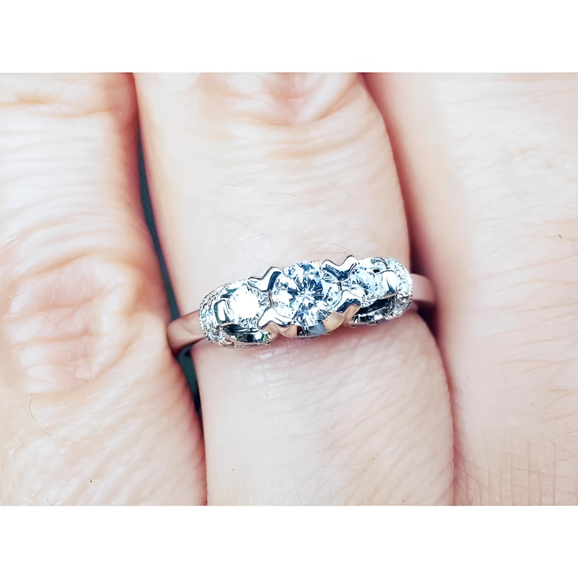 Round cut diamond engagement ring three stone crafted in 14k white gold.