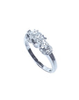 14K white gold three-stone round cut diamond engagement ring with pave set accent diamonds.
