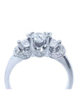 14K white gold three-stone round cut diamond engagement ring with pave accent diamonds.