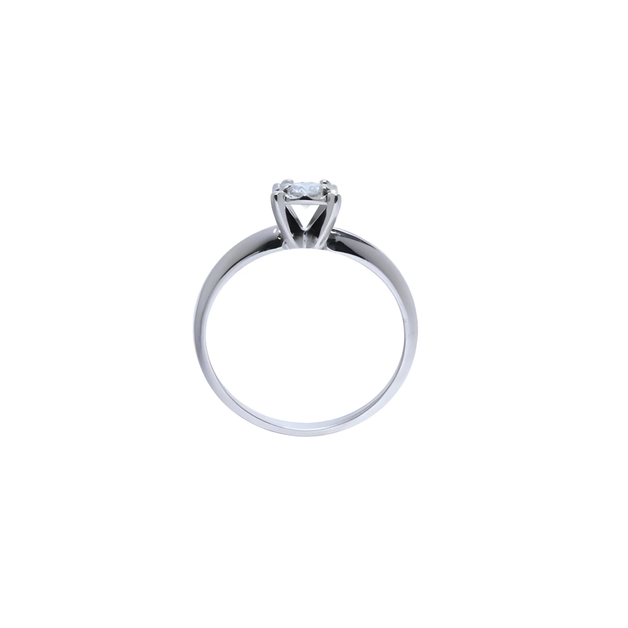 Round cut diamond solitaire engagement ring in 14K white gold with an illusion setting.