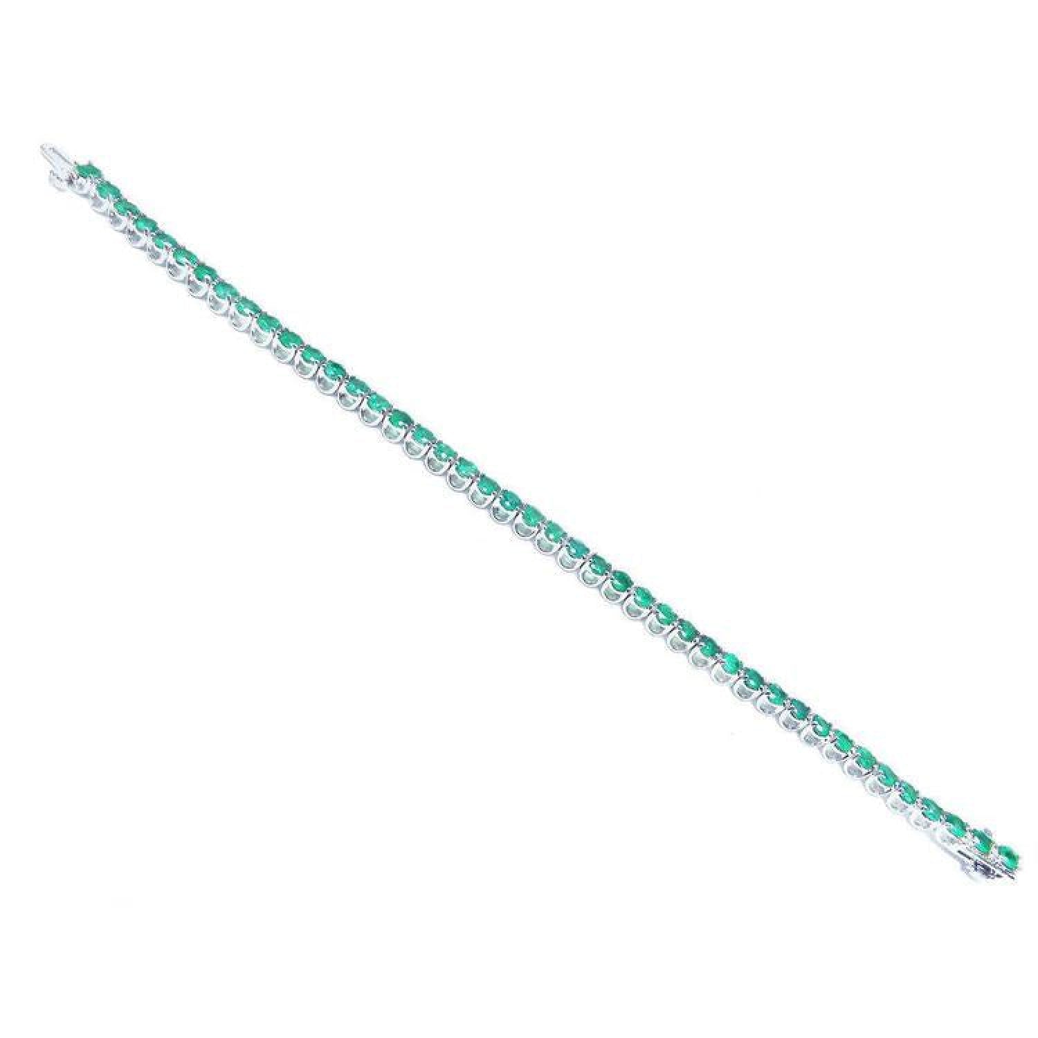 Colombian emerald tennis bracelet with round cut green emeralds in 14K white gold.