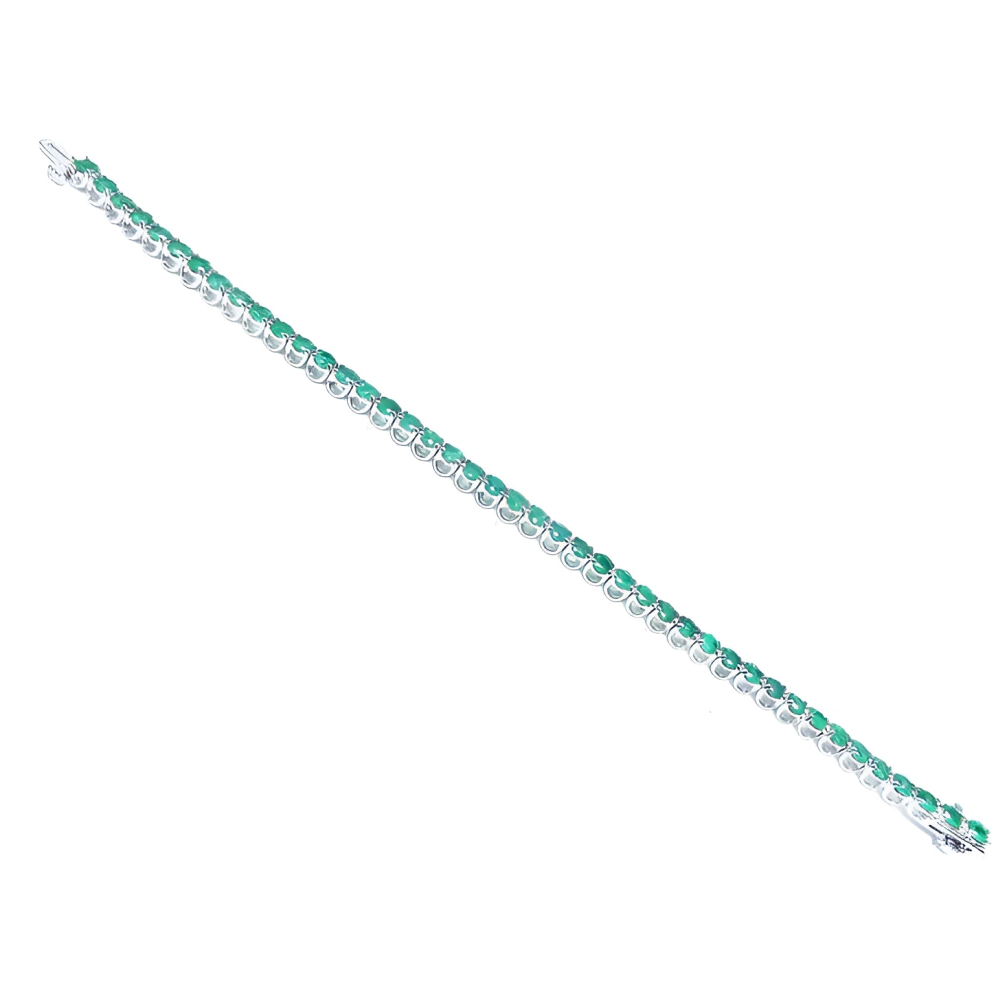 Colombian emerald tennis bracelet with round cut green emeralds in 14K white gold.