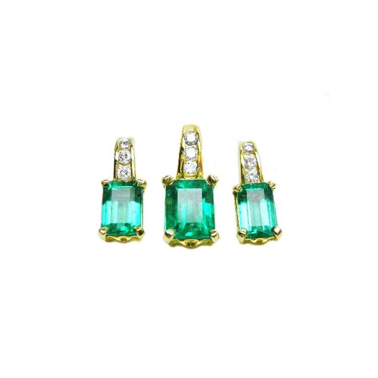 Front position of a trio set of emerald earrings and pendant, accent diamonds in 14k yellow gold, full top side view