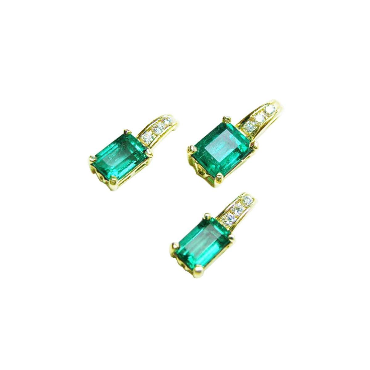 A trio matching set of emerald earrings and pendant in 14k yellow gold, left side position and top view