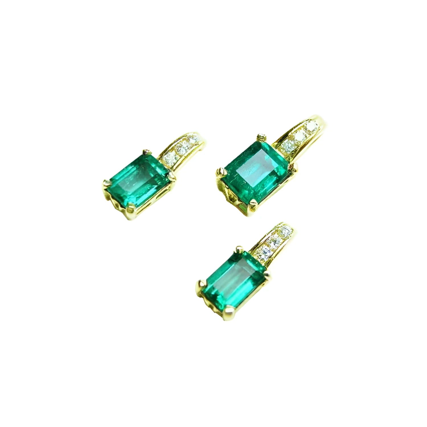 Three emerald-cut Colombian emeralds in 14K yellow gold settings with diamond accents.