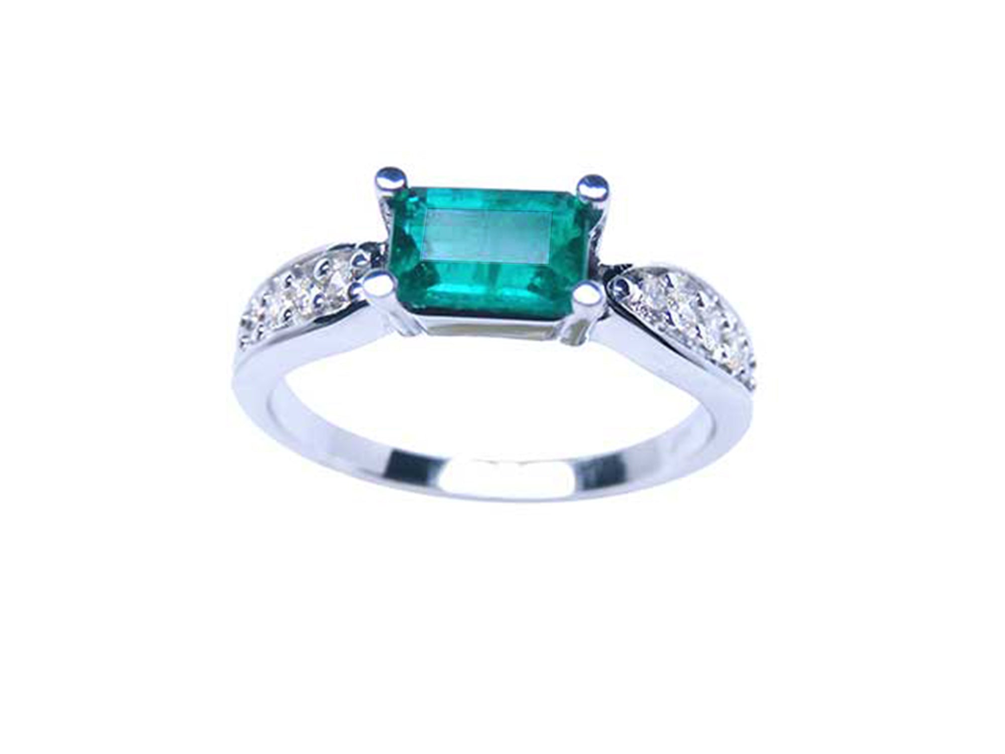 A colombian emerald ring east-west style with accent diamonds in white gold, top and sides profile view.
