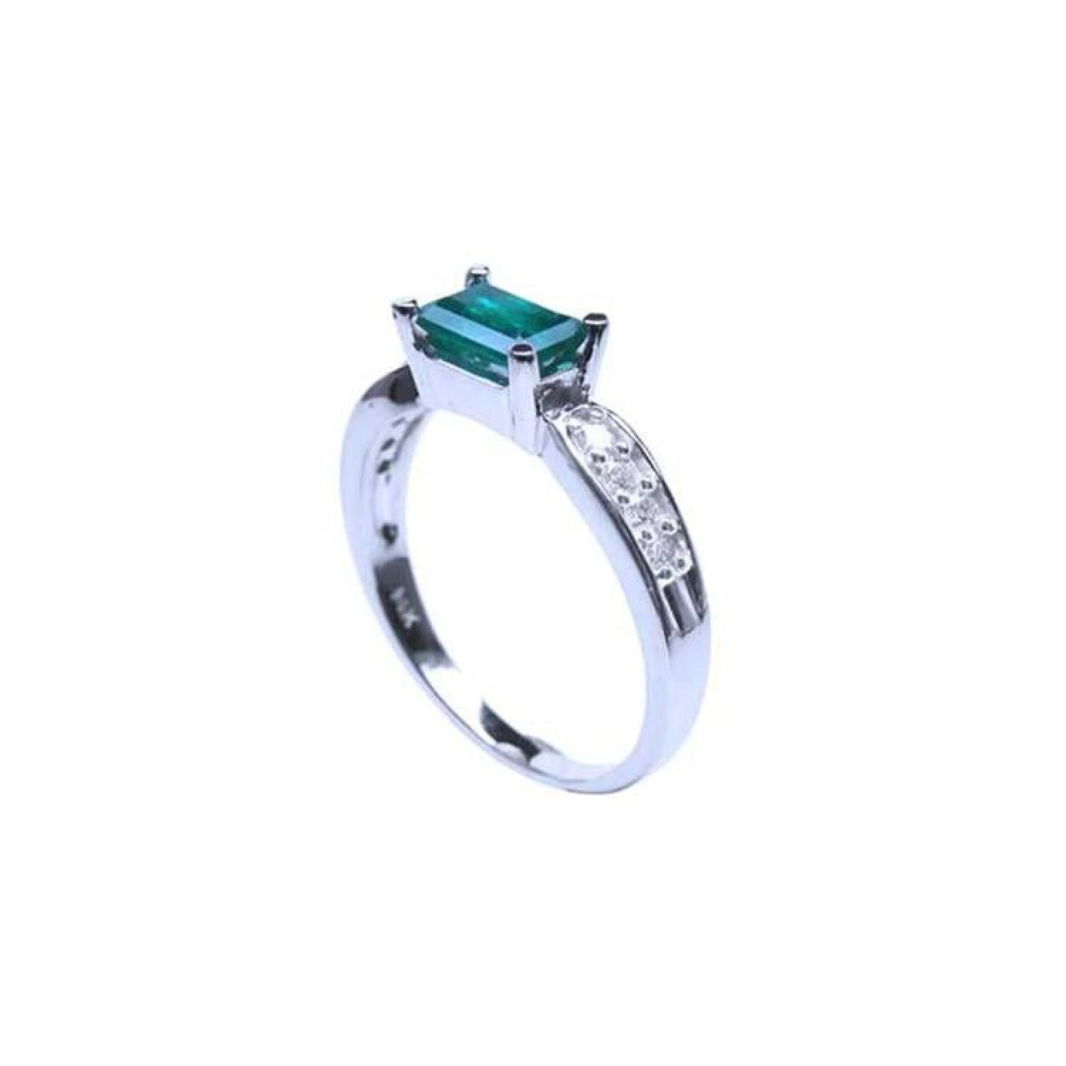 0.90 ct. east west emerald ring in 14k white gold with side diamonds.