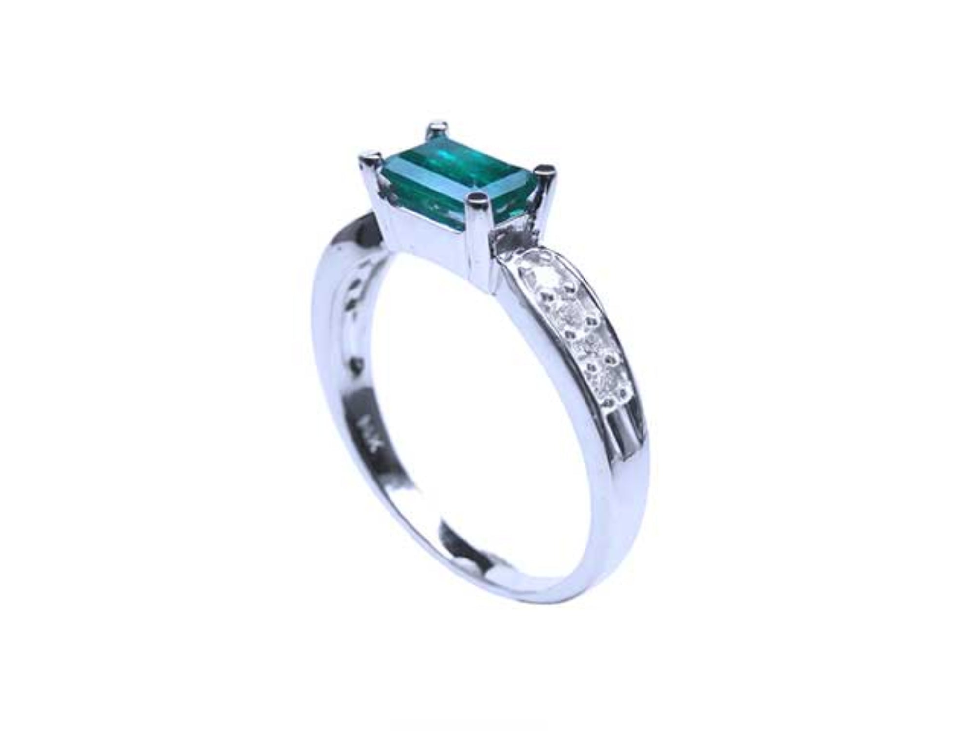 This emerald ring on top shows te lateral side and band with accent diamonds.