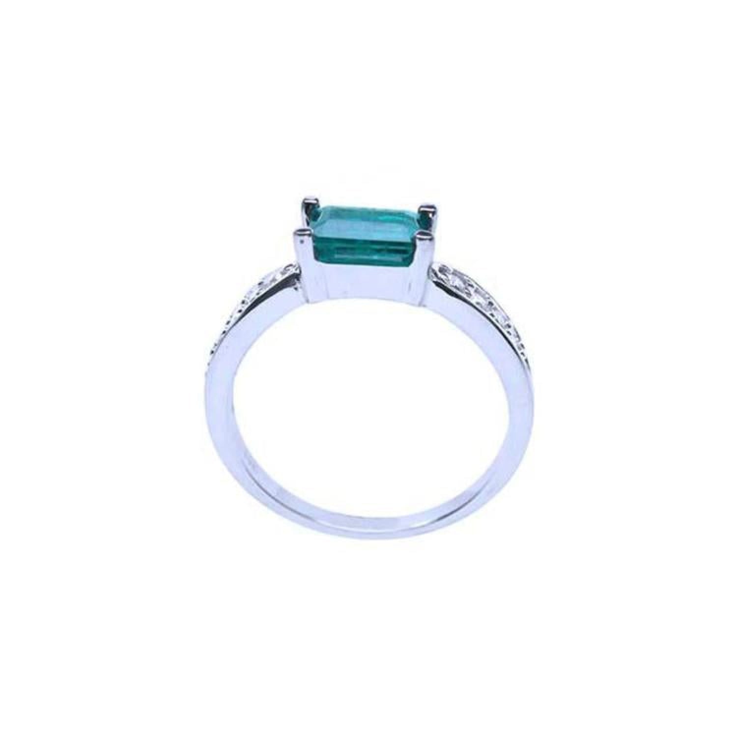 East West emerald ring with a vivid green emerald and diamond accents on a 14k white gold band.