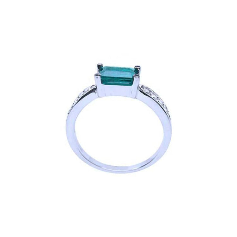 East West emerald ring with a vivid green emerald and diamond accents on a 14k white gold band.