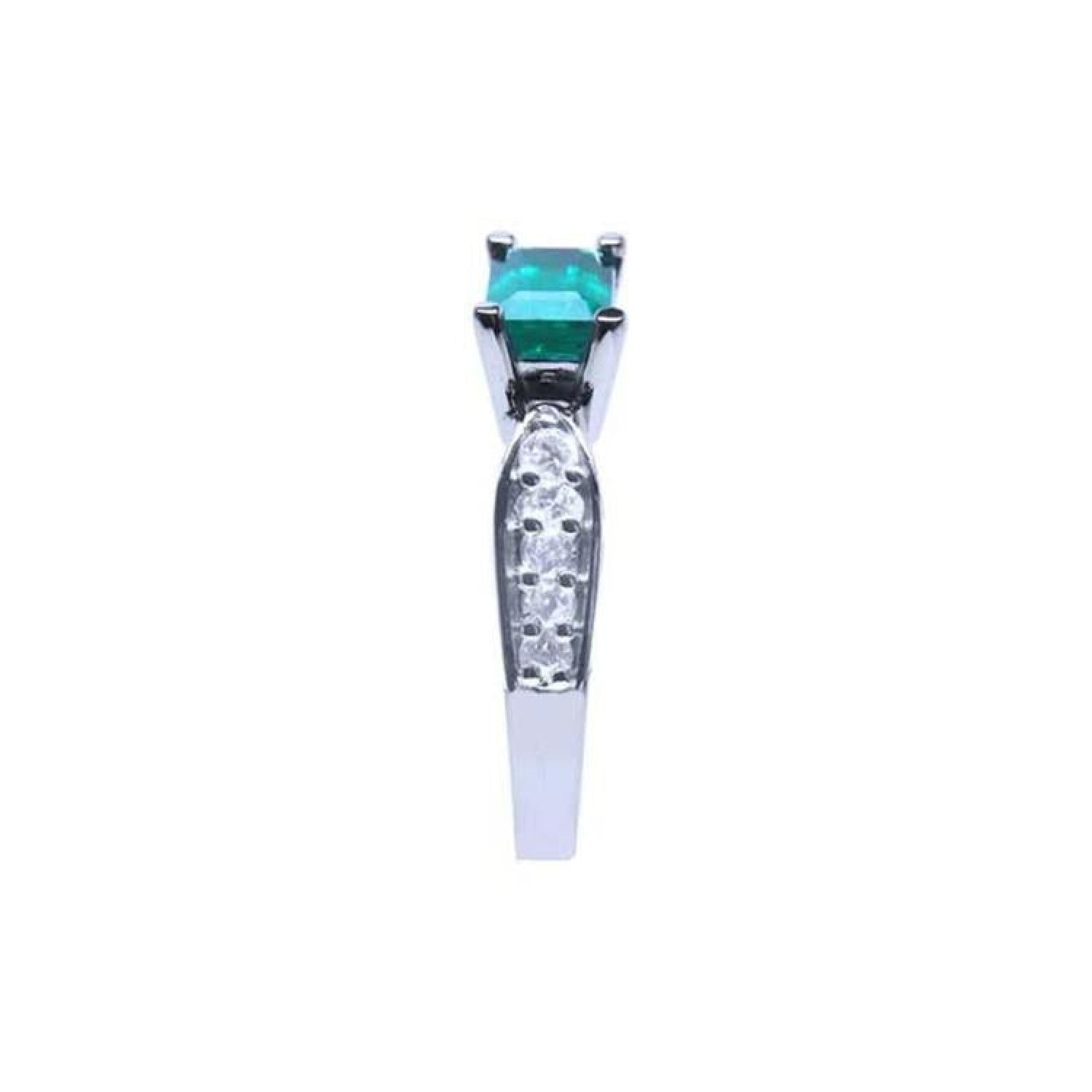 East-west emerald ring with a vivid green emerald and diamond accents on a 14k white gold band.