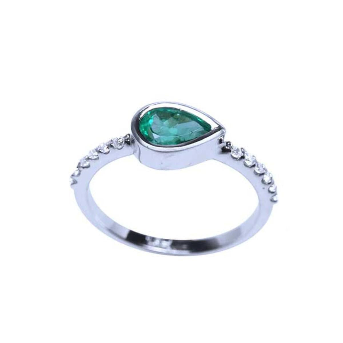 The top and side profile view of a teardrop emerald bezel set ring with accent diamonds in white gold.