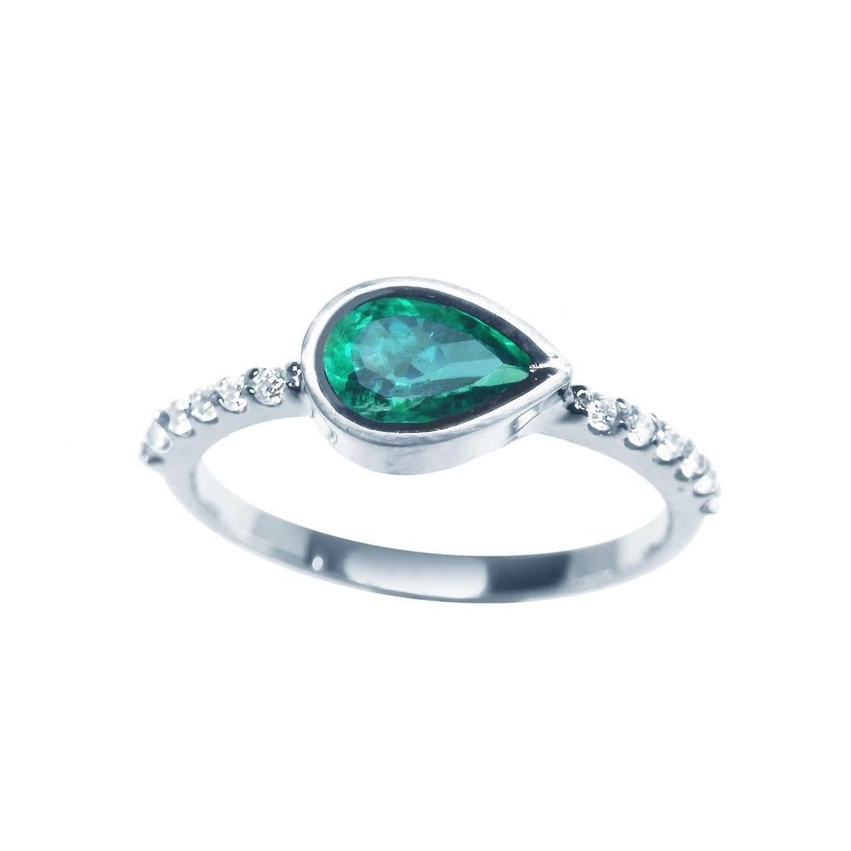 A teardrop emerald bezel set ring with accent diamonds in white gold displaying the topside view