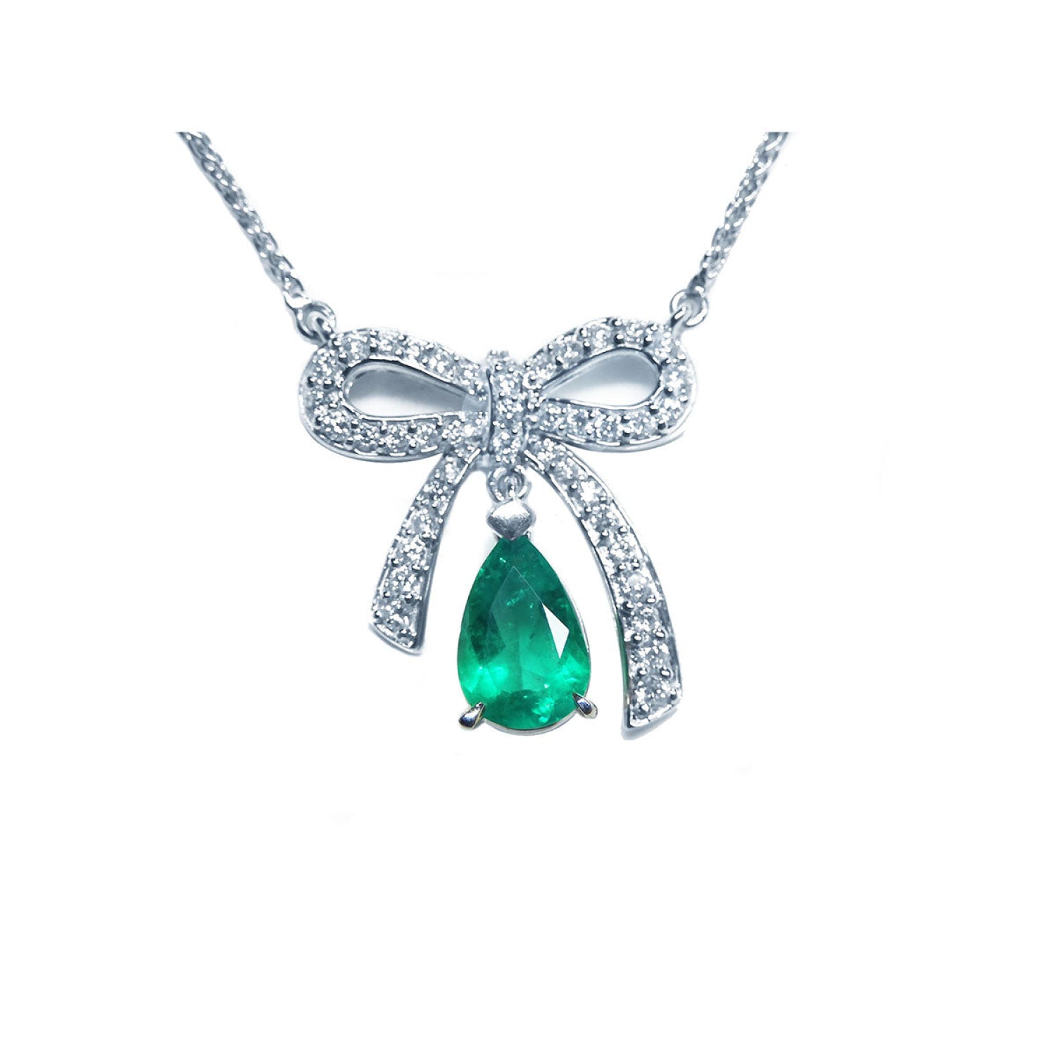 18K white gold bow-tie necklace with a deep green pear-shaped emerald pendant.