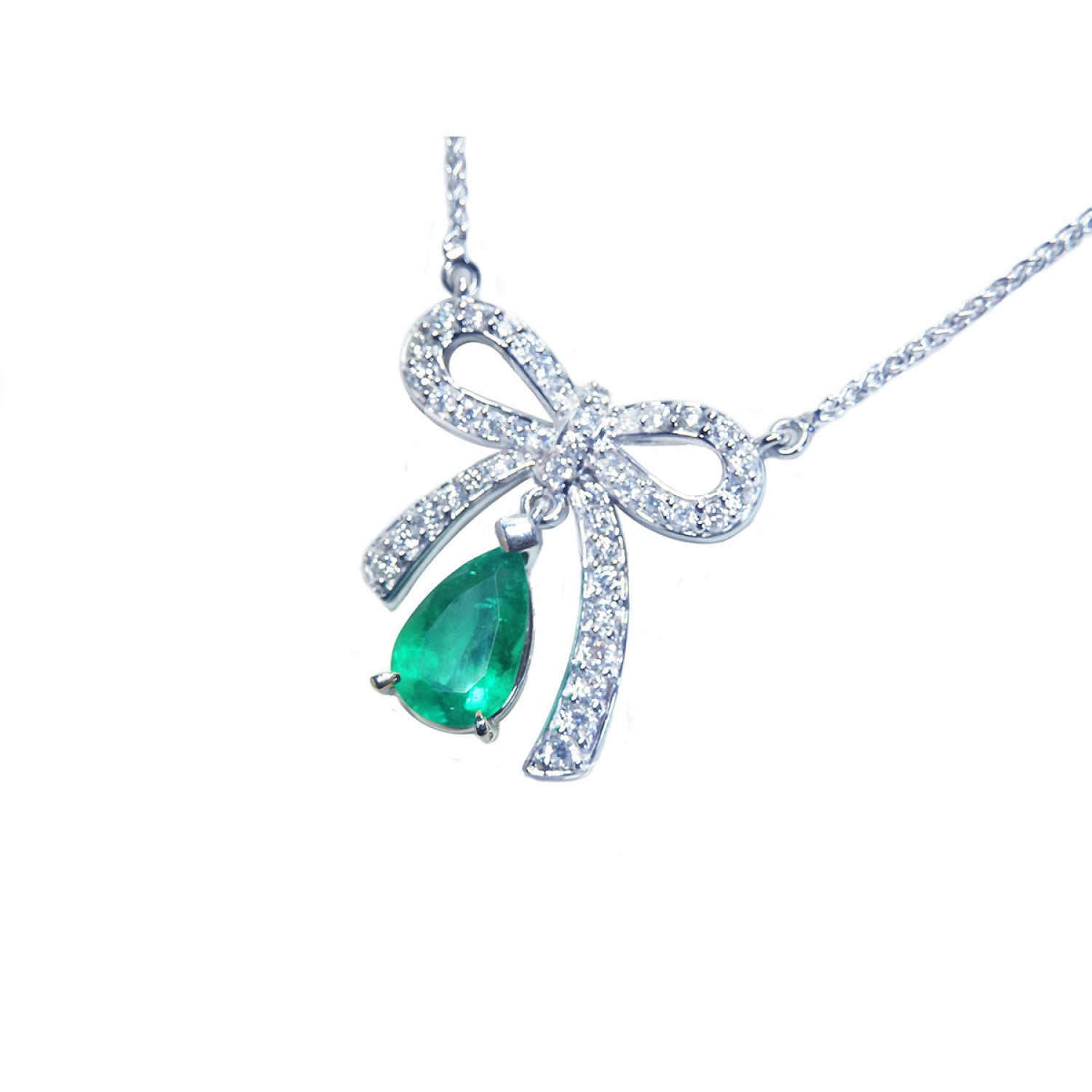 18K white gold bow-tie necklace with a pear-shaped deep green emerald.