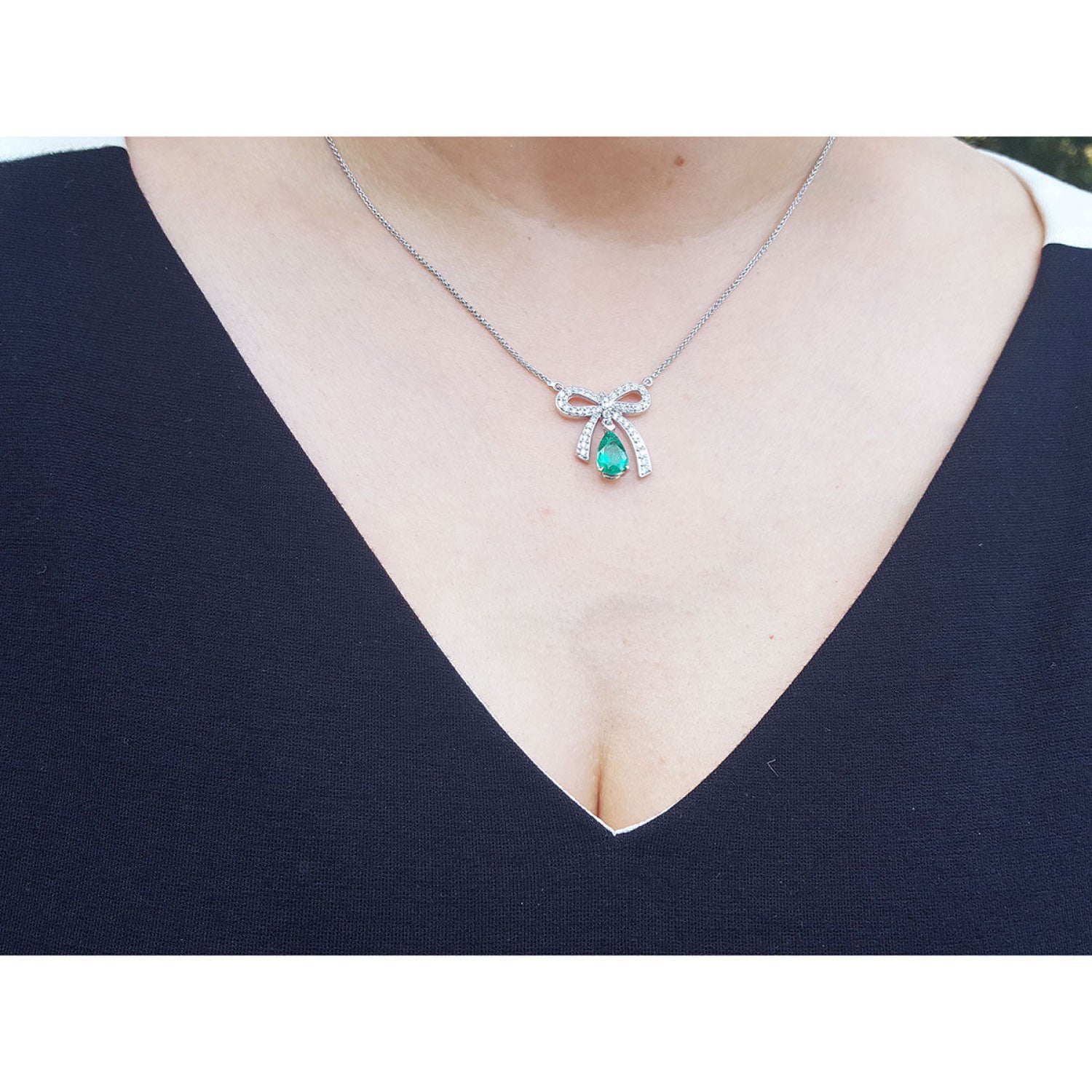 Emerald bow tie necklace, pear-shaped 1.28 ct. deep green emerald, 18K white gold.