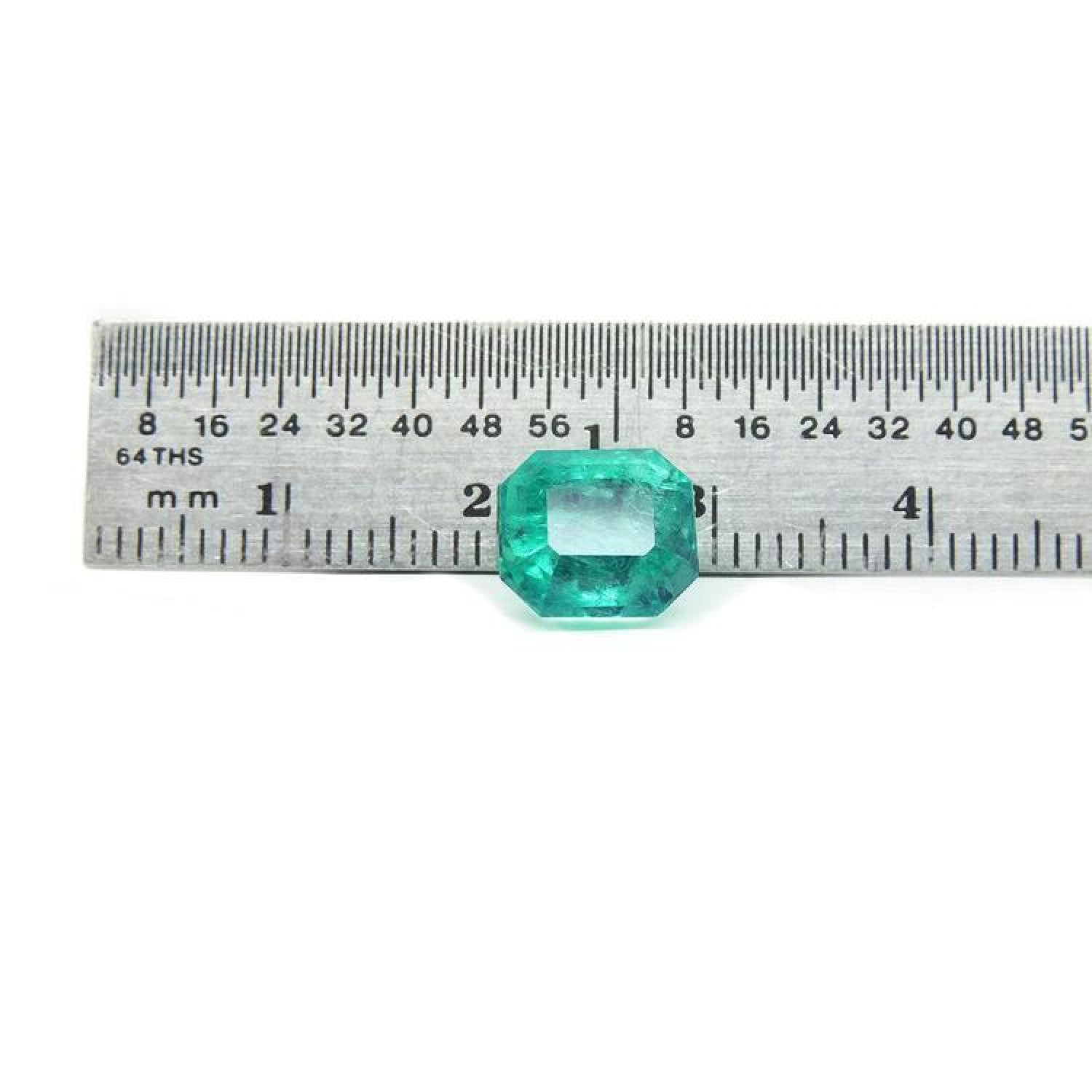 2.95 ct square natural Colombian emerald with bright medium green hue, shown on a ruler.
