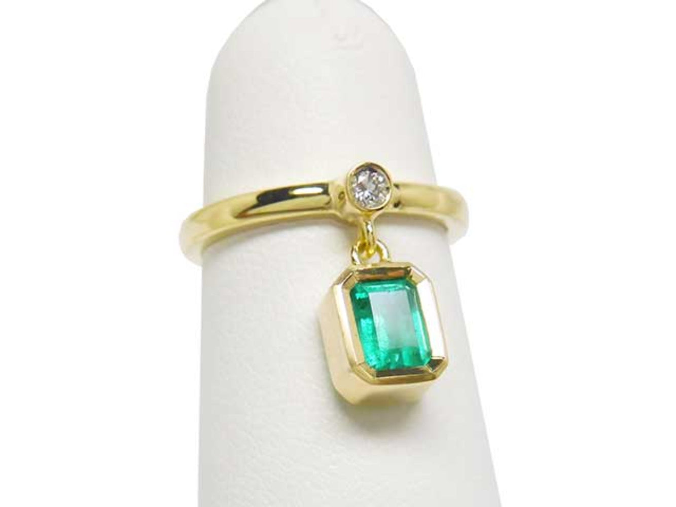 Front position of an emerald dangle ring representing May&#39;s birthstone jewelry.