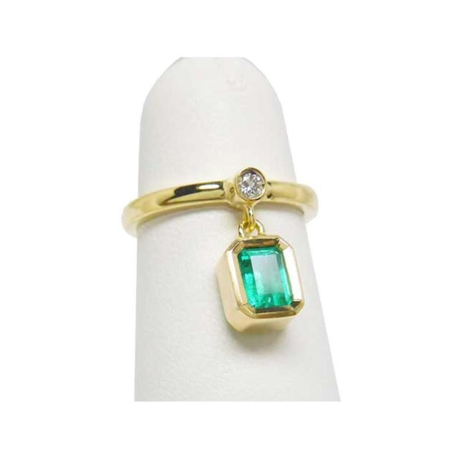 14K yellow gold dangle ring with a bezel-set emerald and small diamond accent.