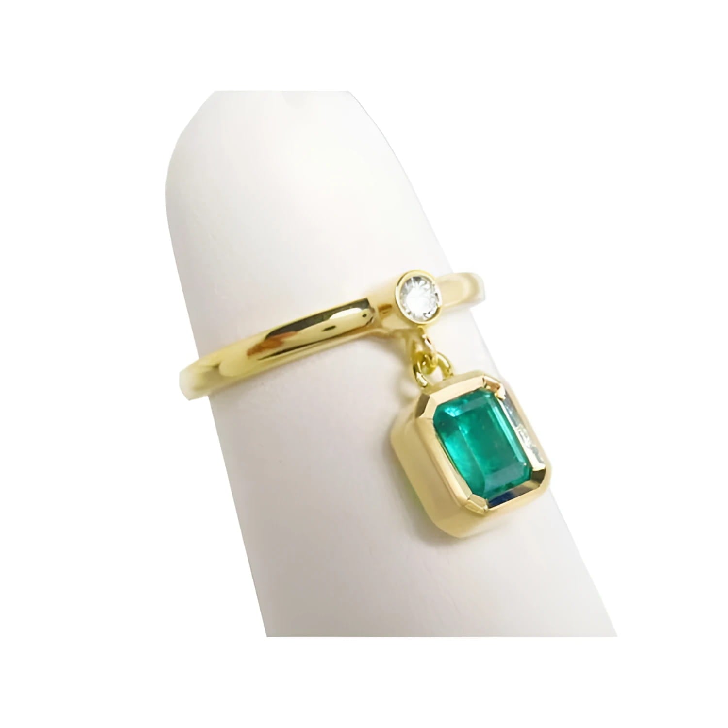 14K yellow gold ring with a bezel-set emerald dangle and a small round diamond accent.