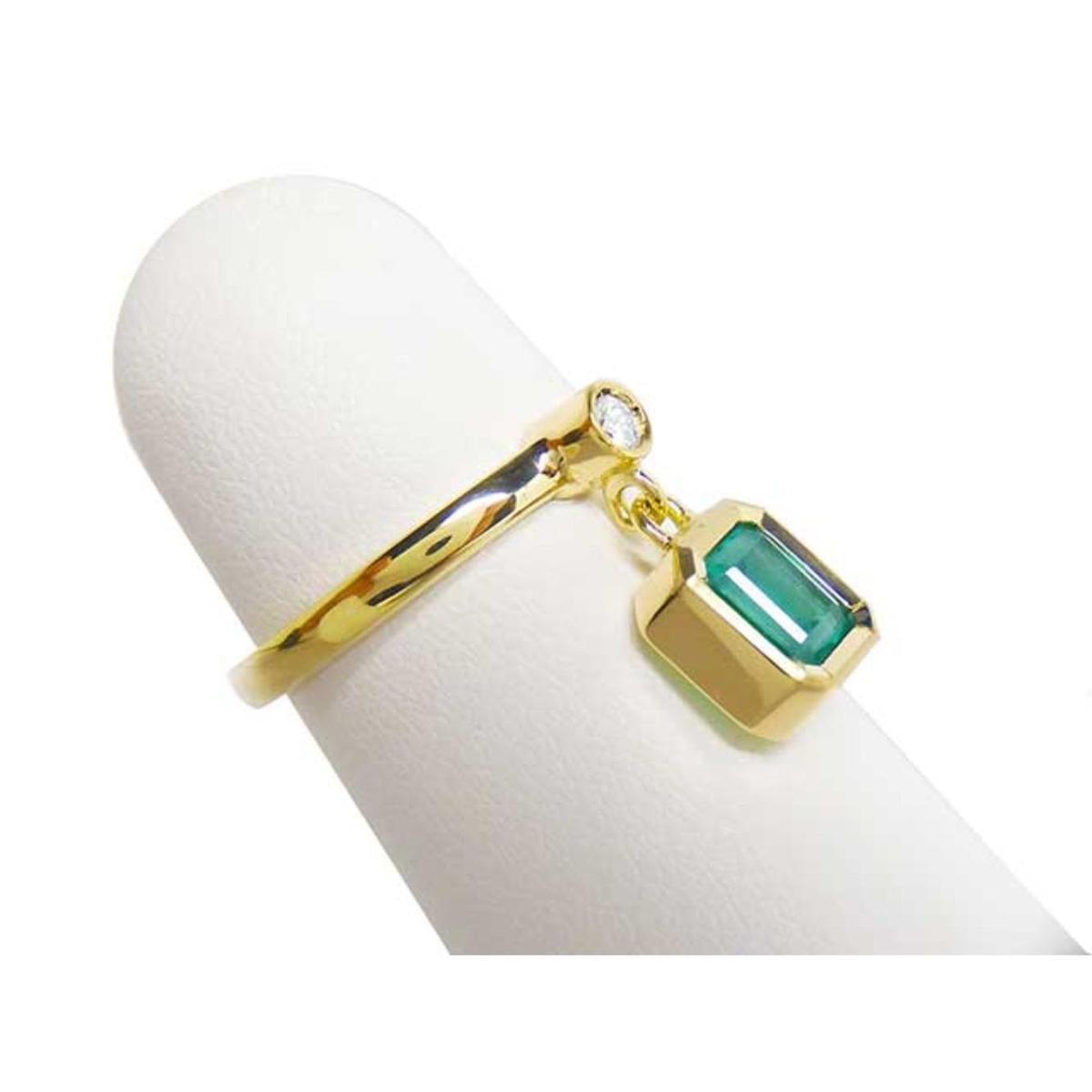 A natural emerald dangle ring representing May's birthstone jewelry in 14k yellow gold.