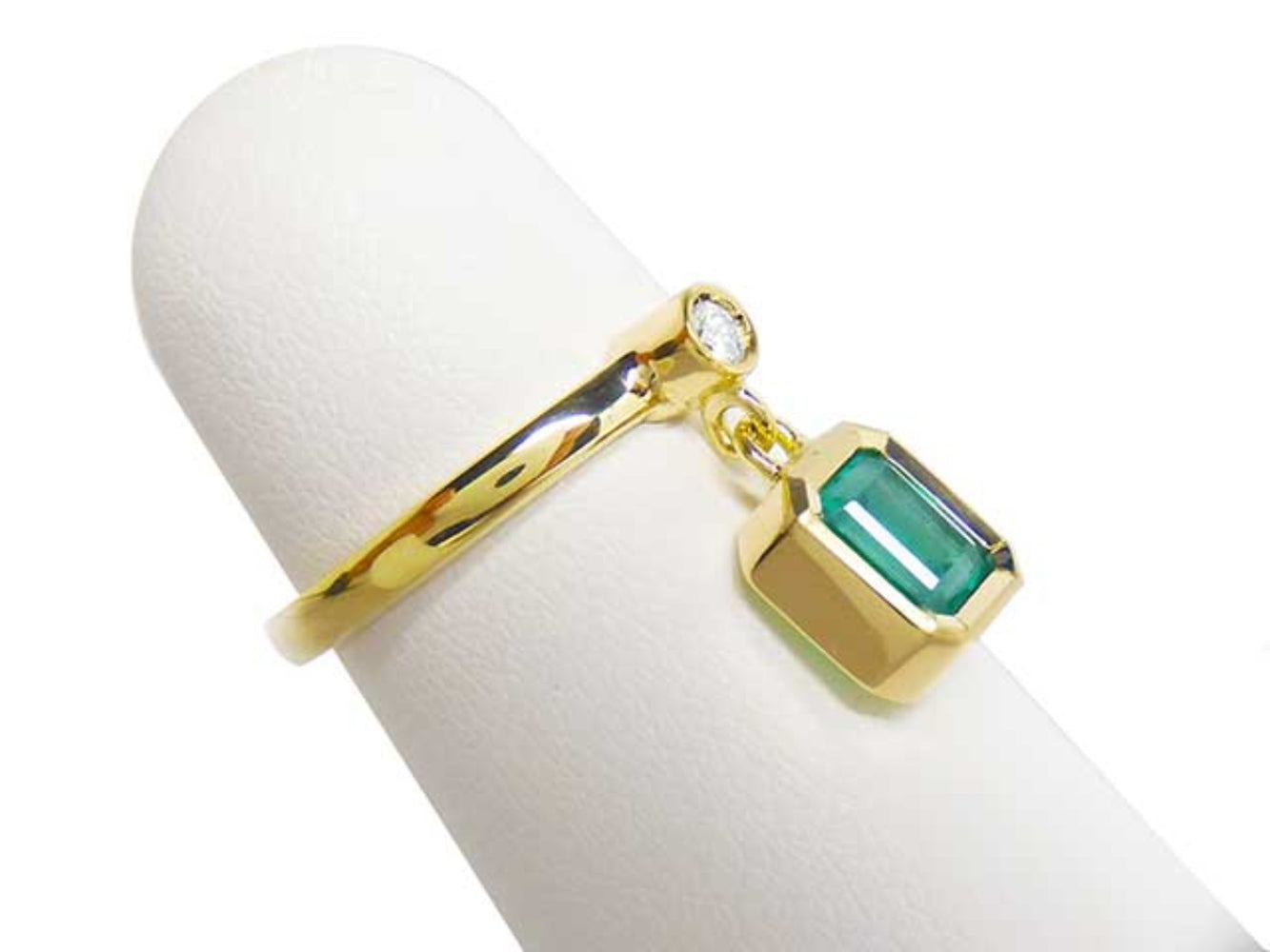 A natural emerald dangle ring representing May's birthstone jewelry in 14k yellow gold.