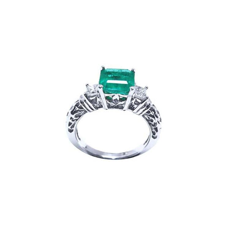 1.48 ct. emerald engagement ring with two side diamonds and intricate band in 14K white gold.