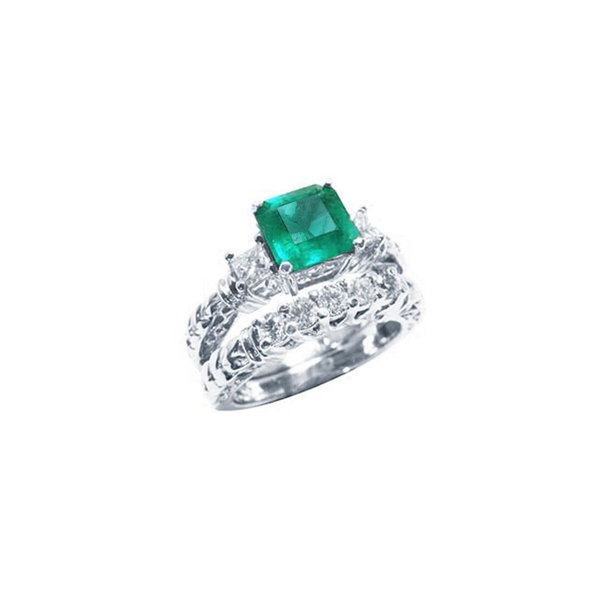 Emerald engagement ring with matching wedding band in white gold.