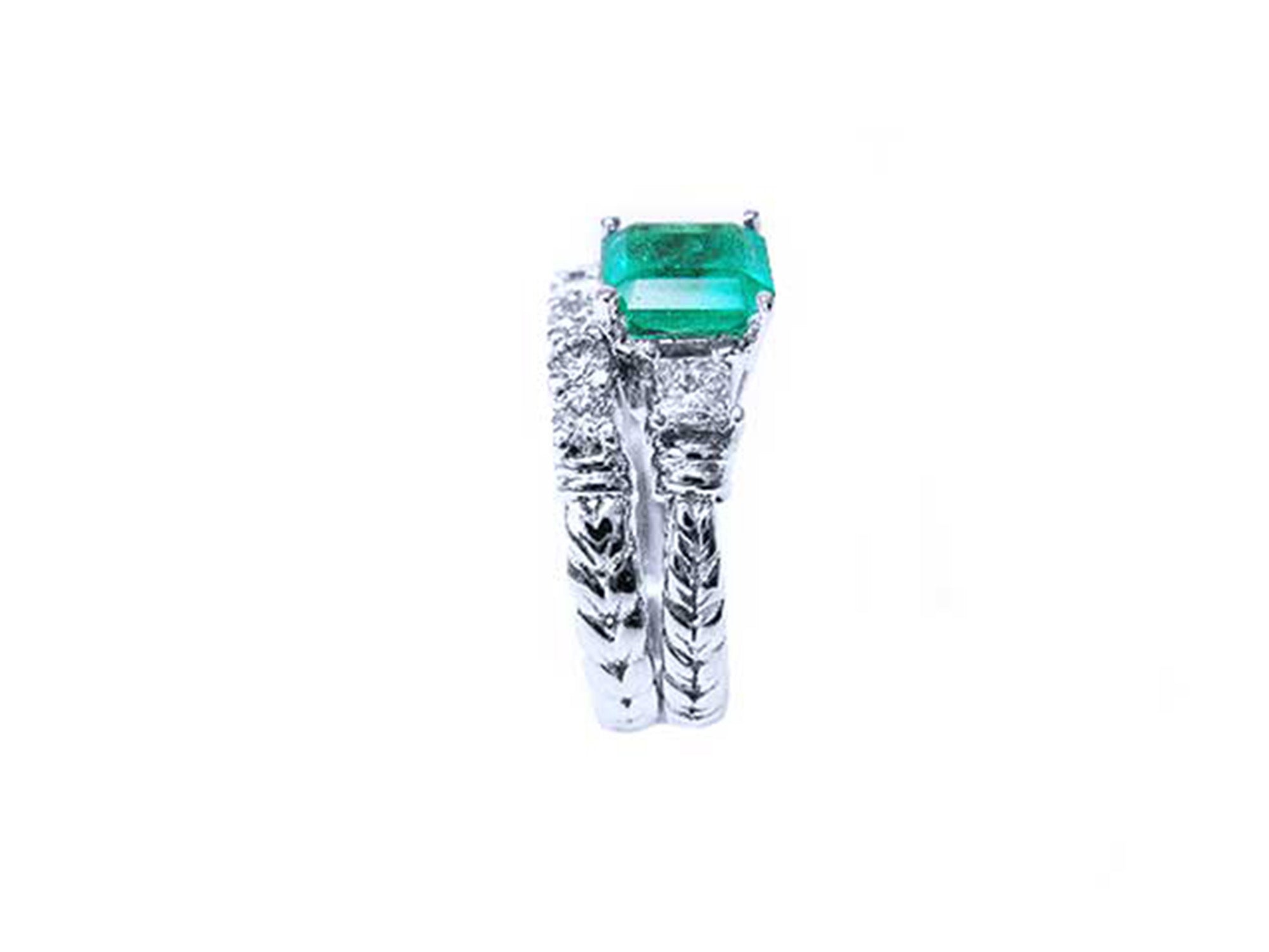 Side profile of a bridal&#39;s emerald engagement ring and matching wedding band white gold.