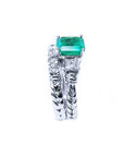 Side profile of a bridal's emerald engagement ring and matching wedding band white gold.
