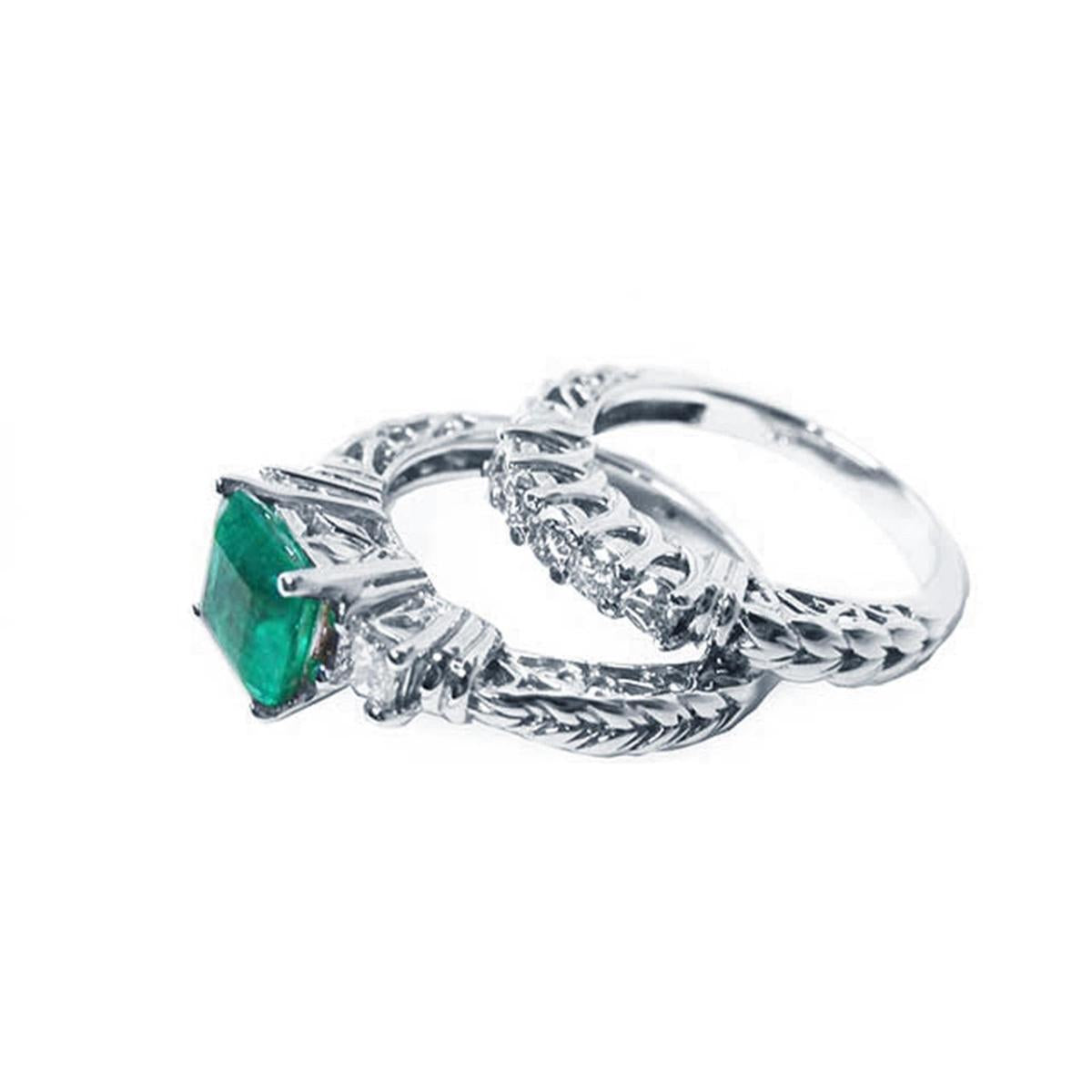 Emerald ring and diamond wedding band on lateral position.