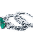 Emerald ring and diamond wedding band on lateral position.