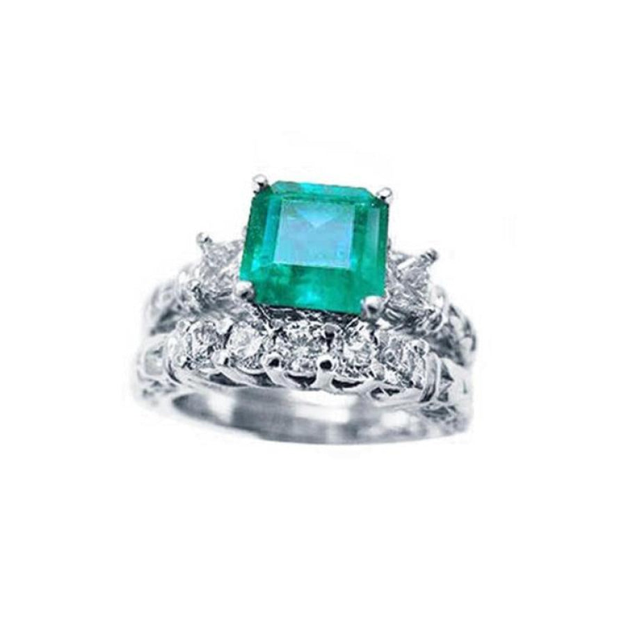 A Muzo Colombian emerald ring with a diamond matching band set in white gold.