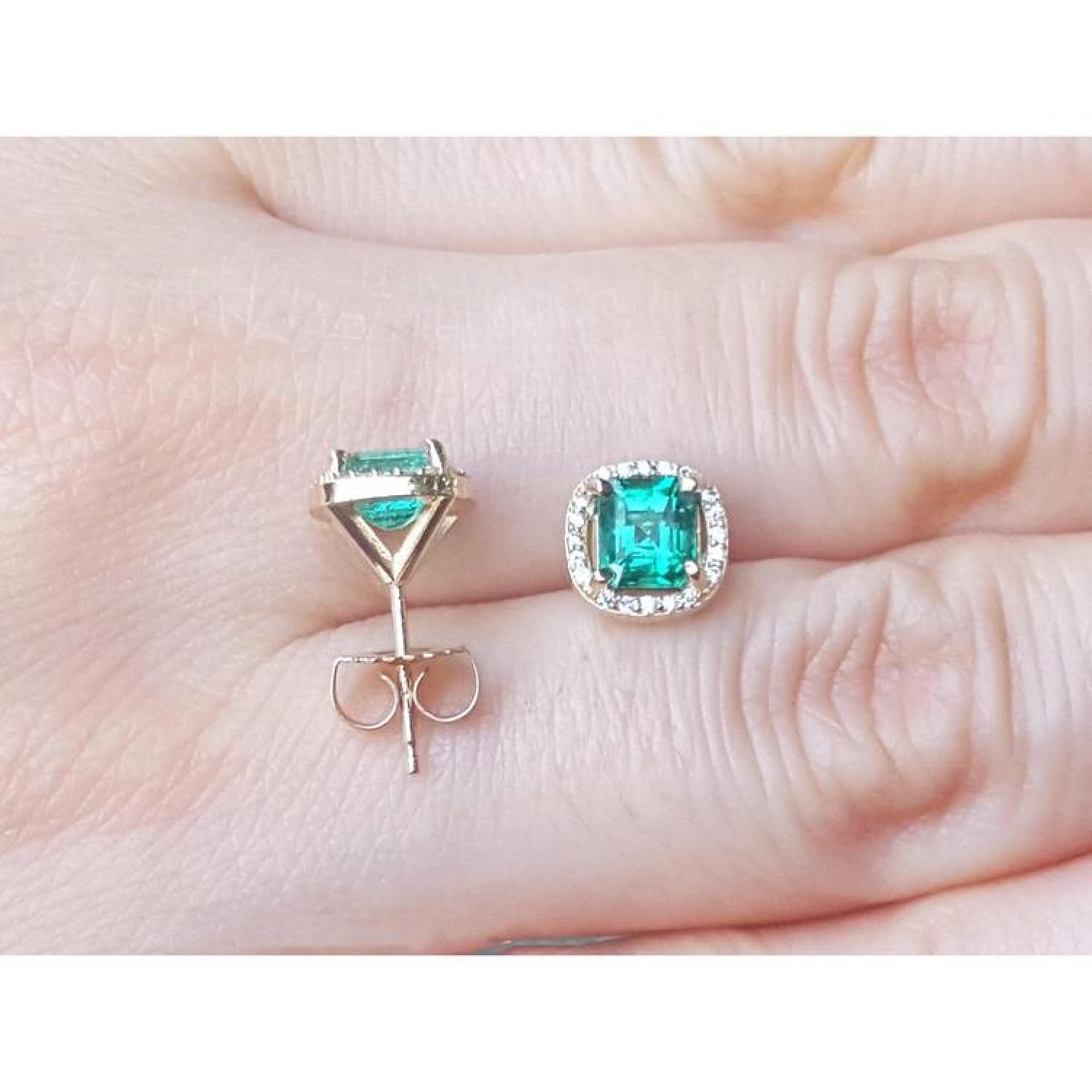 1.55 carat emerald halo diamond stud earrings in 14K yellow gold, one front view, one back view.