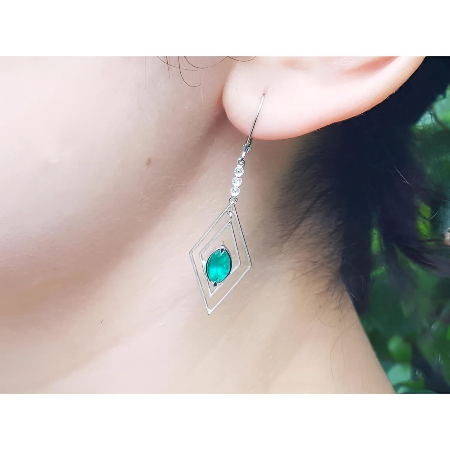 Emerald marquise earrings with deep bluish-green gems in a double marquise 14K white gold frame.