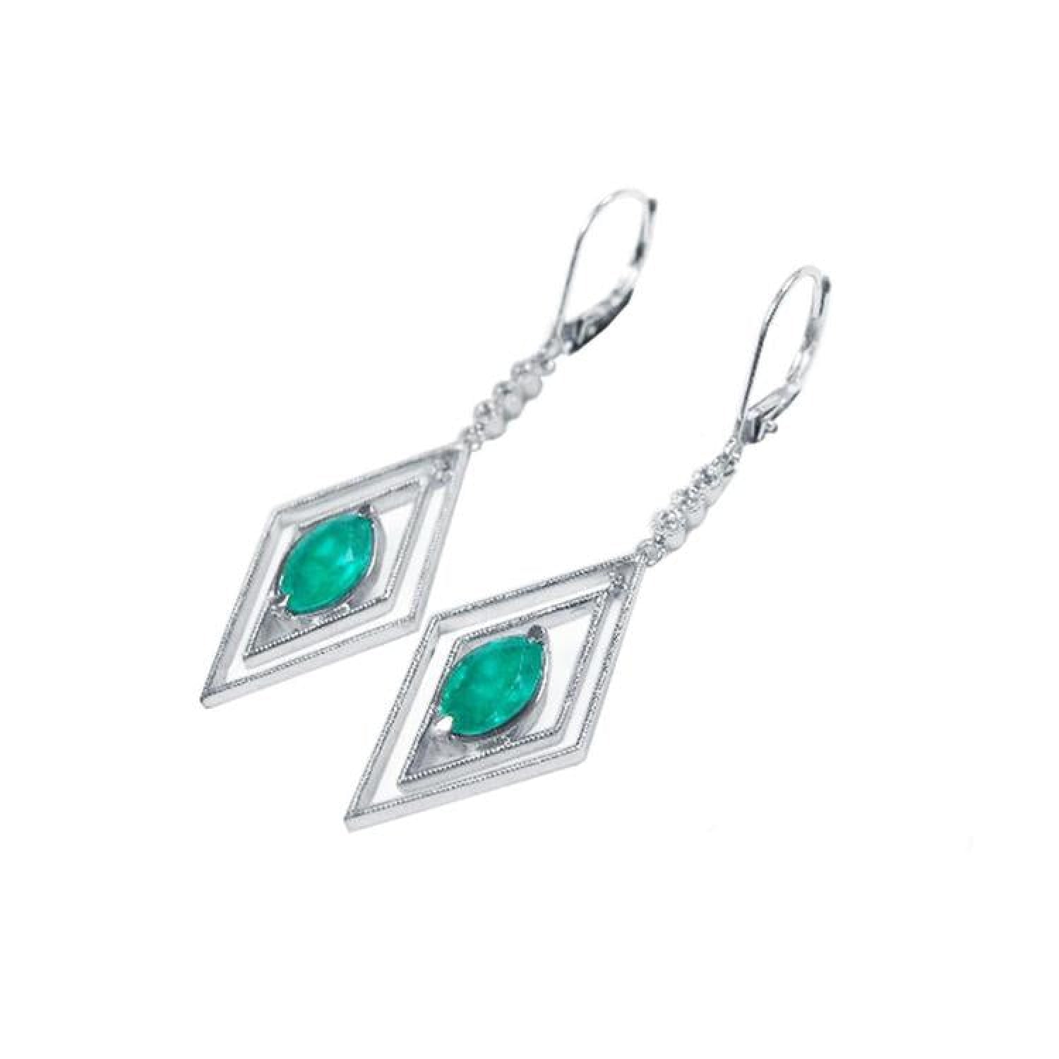 14K white gold emerald marquise earrings with deep bluish-green gems in double diamond frames, dangling from lever backs.
