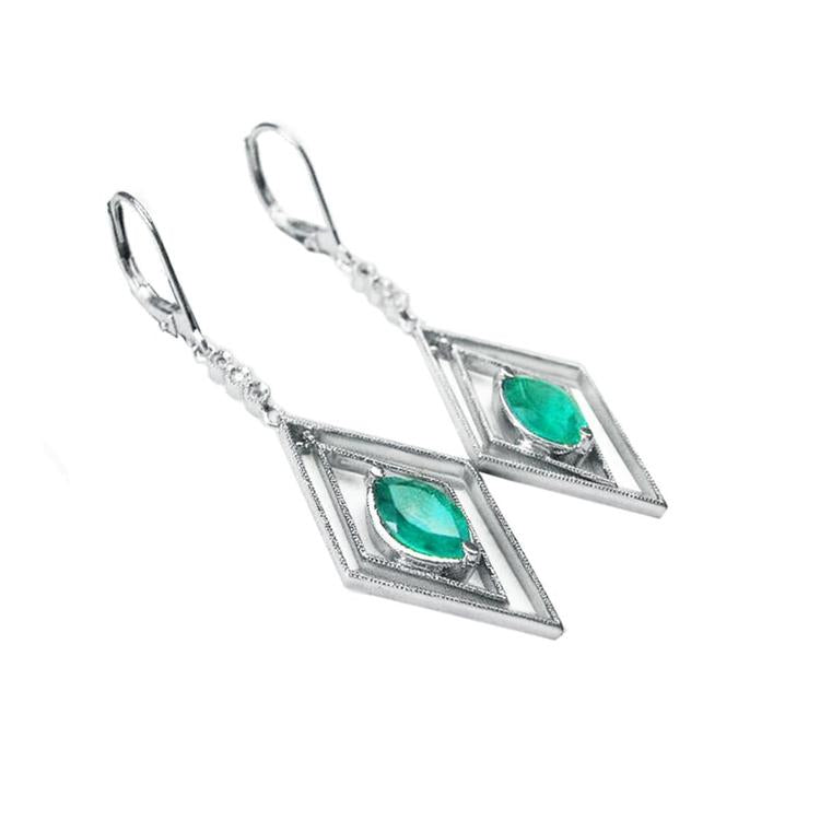 Pair of white gold emerald marquise earrings with lever backs on a left-side position and top view