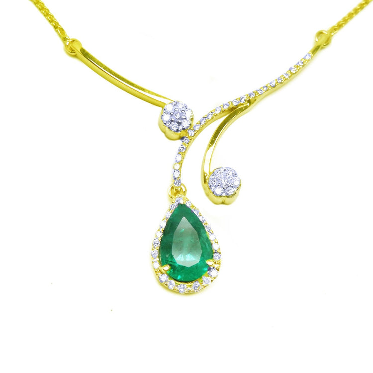 Colombian emerald and accent diamonds sourced from the Muzo mines in Colombia halo diamond set in 18k yellow gold