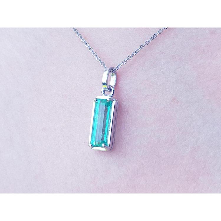 1.70 ct. rectangular Colombian emerald solitaire pendant in 14K white gold on a chain.