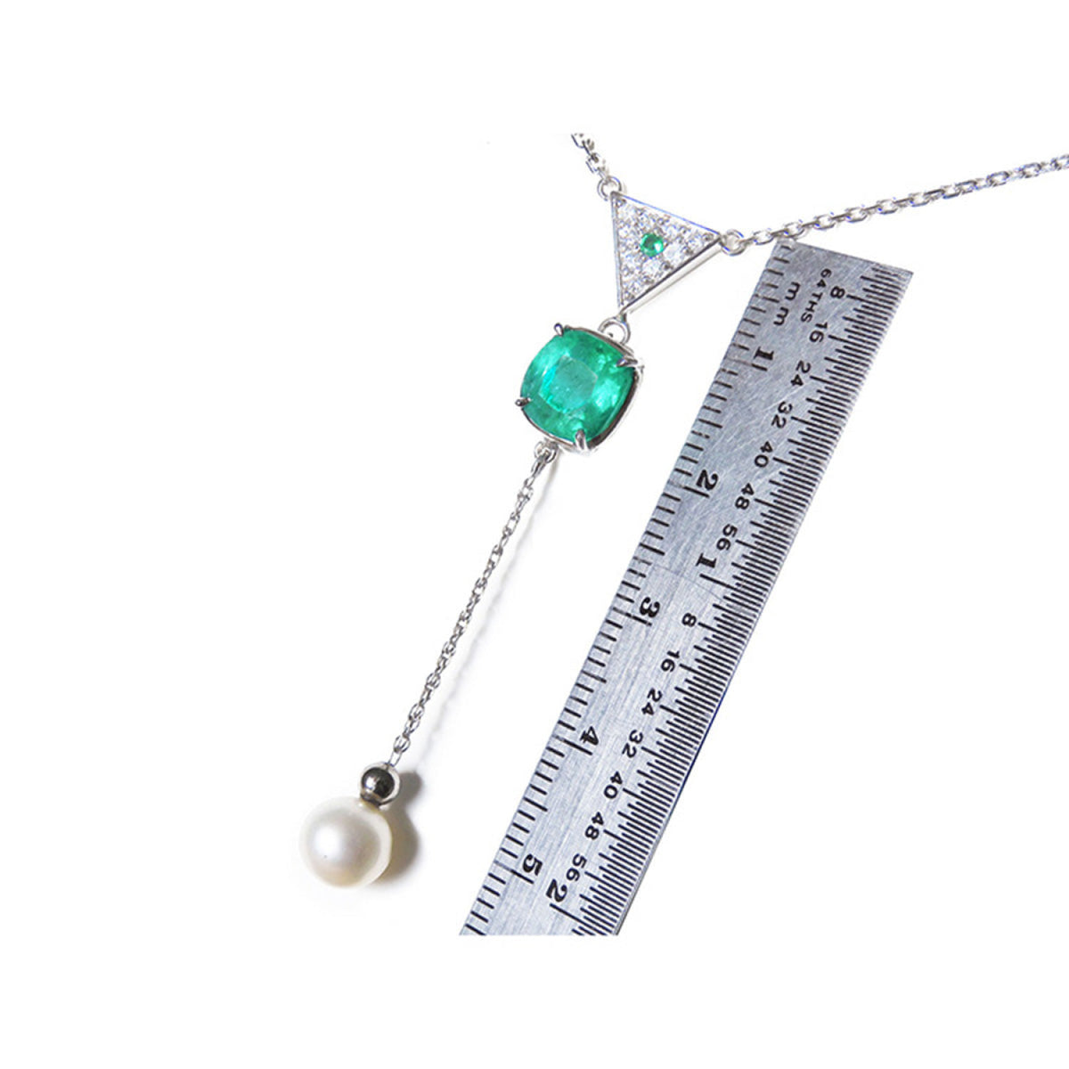 1.91 carat emerald cushion cut necklace with hanging pearl, 14K white gold, shown with ruler.