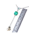 1.91 carat emerald cushion cut necklace with hanging pearl, 14K white gold, shown with ruler.