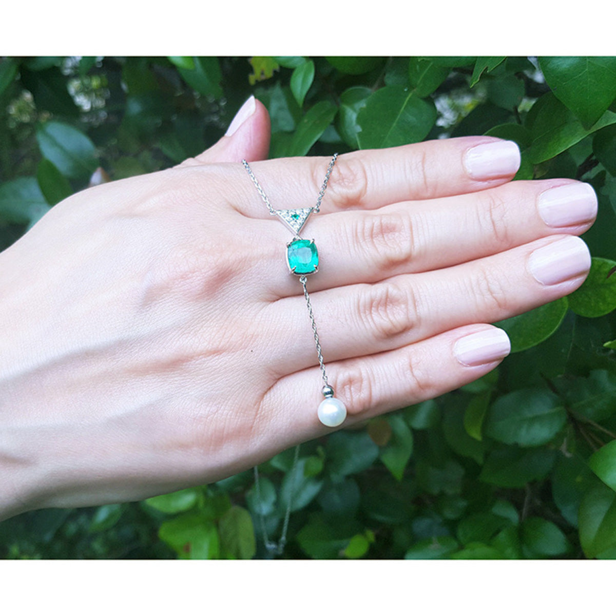 1.91 carat emerald cushion cut necklace with a hanging white freshwater pearl on 14K white gold.