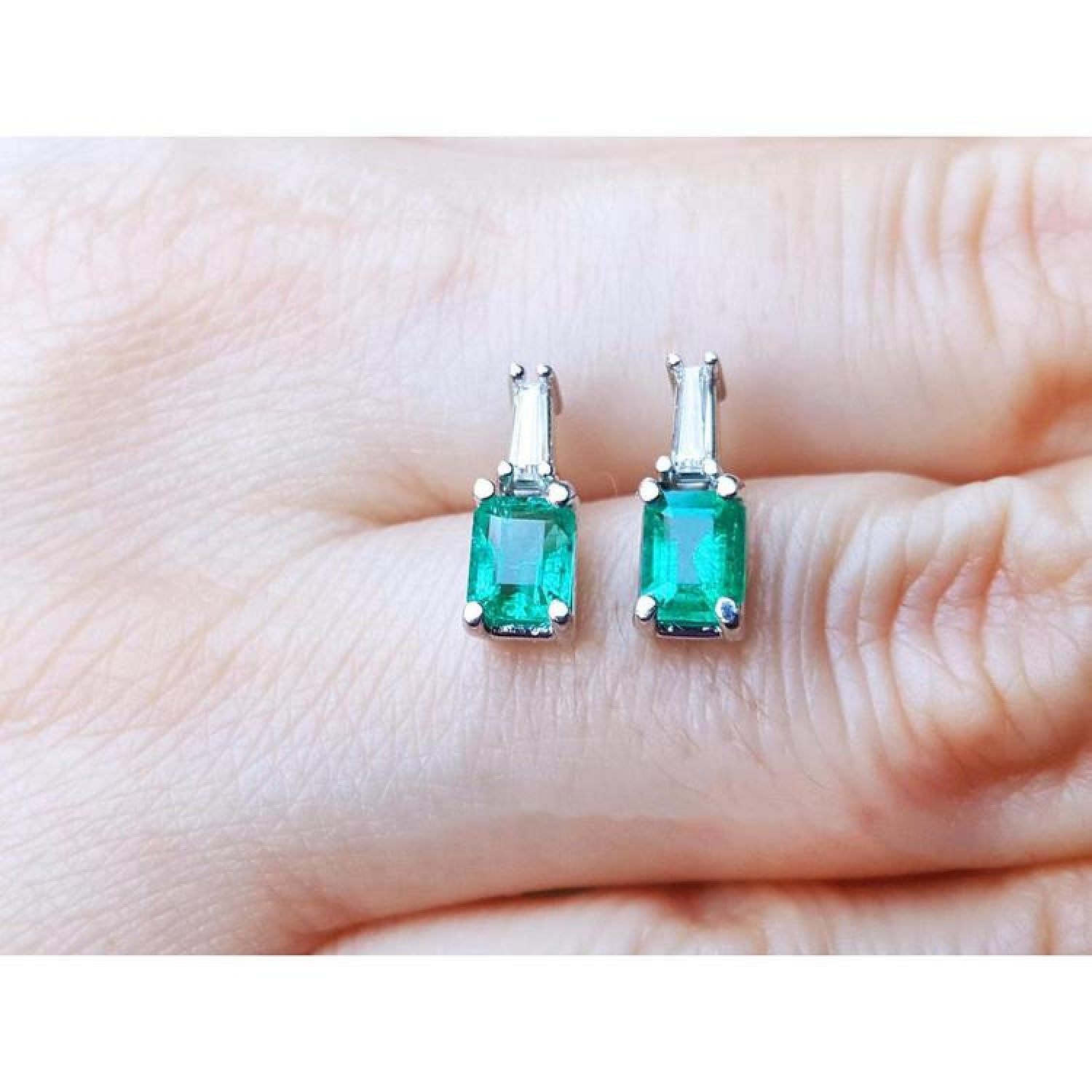 Colombian emerald and baguette diamond stud earrings, 14K white gold.
