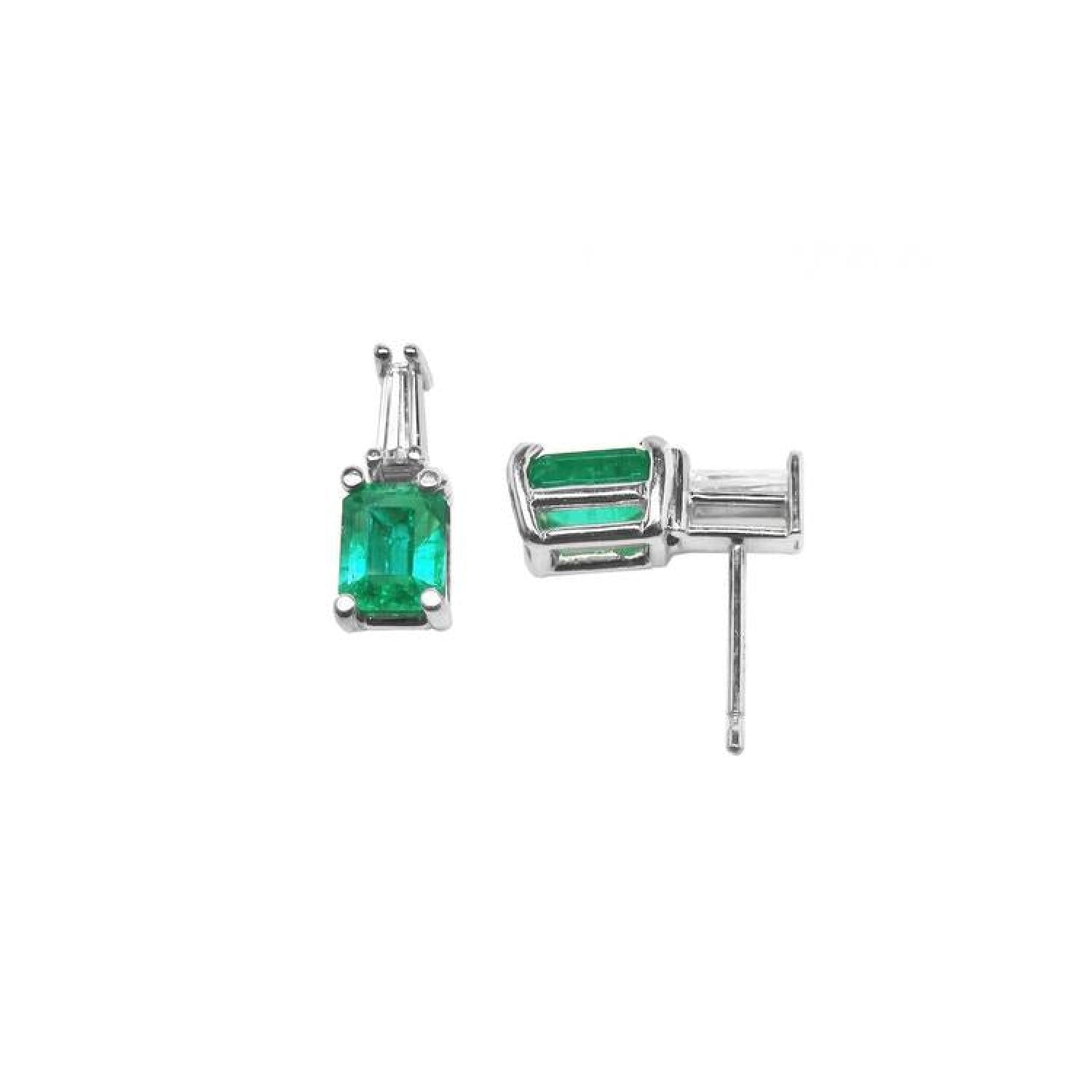 Colombian emerald and baguette diamond stud earrings in 14K white gold.