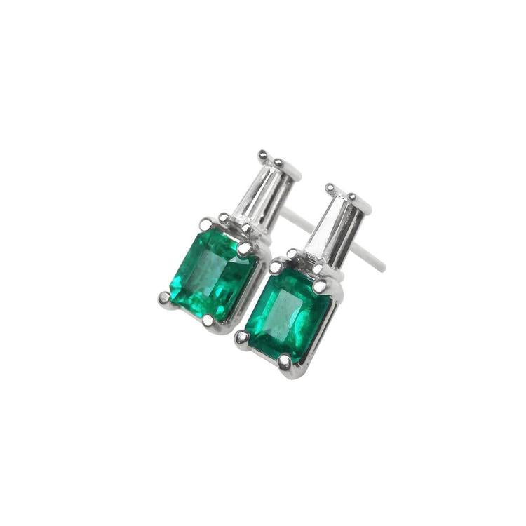 A pair of Colombian emerald and baguette diamond stud earrings, left side profile view.