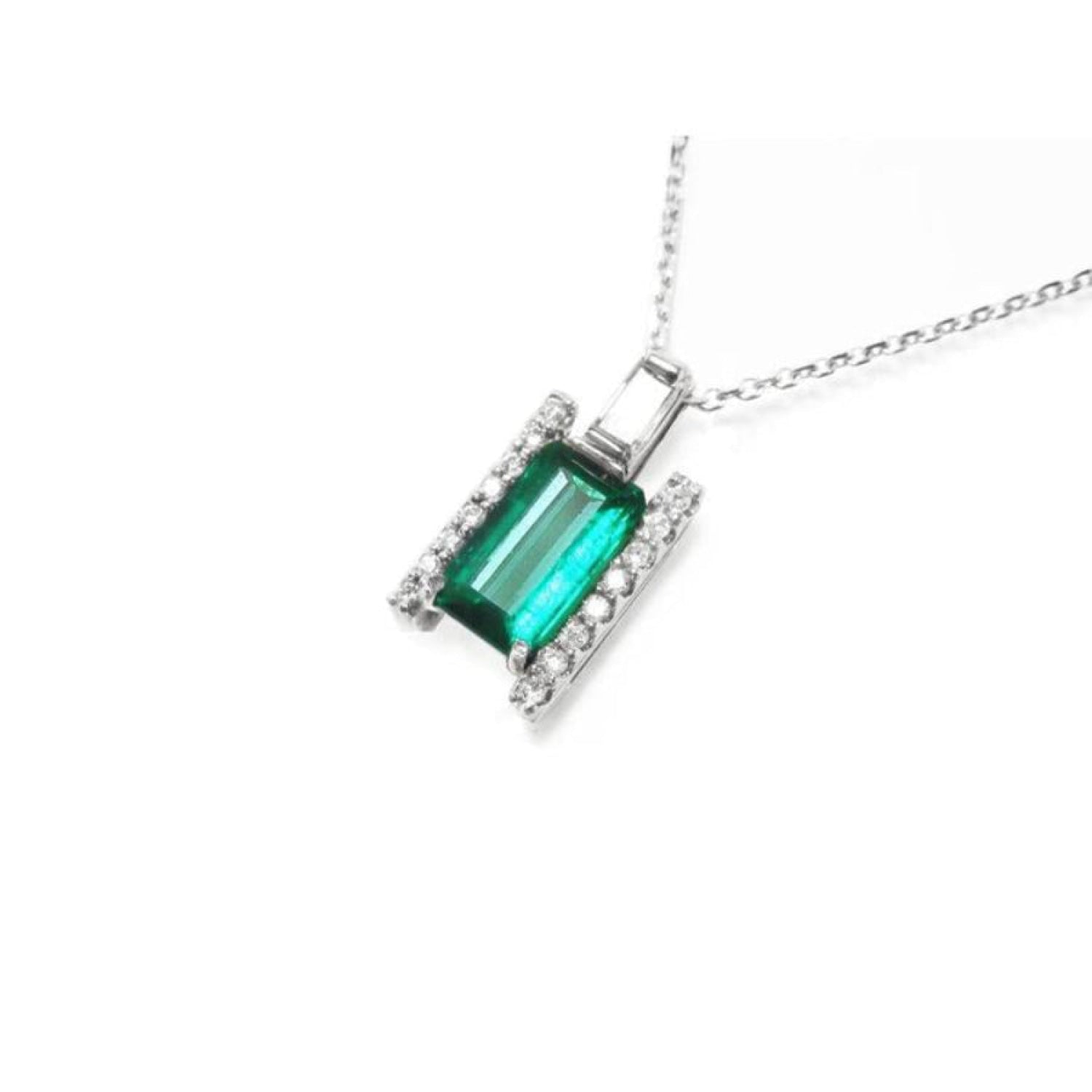 Baguette cut Colombian emerald and diamond pendant necklace in 14K white gold.