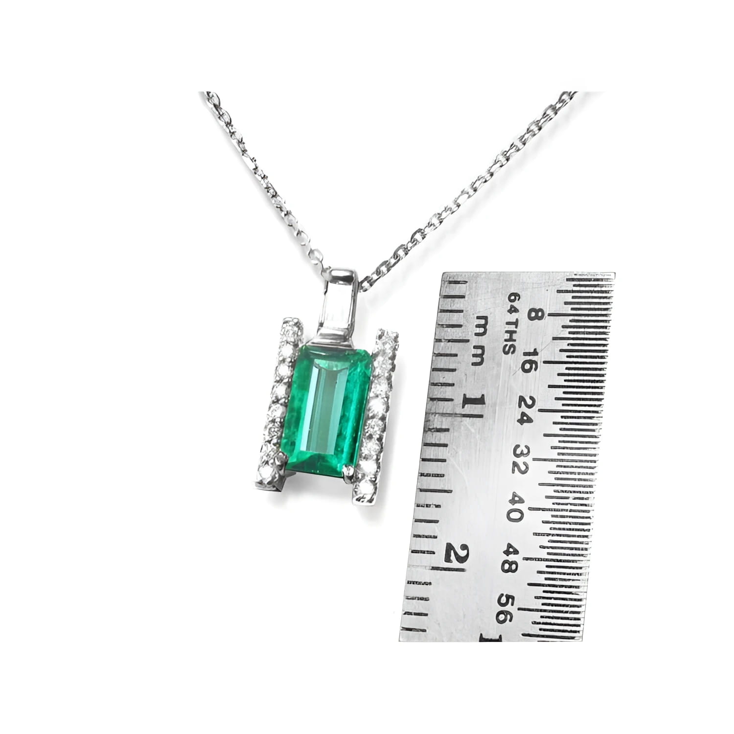 0.75 ct. baguette cut emerald and diamond pendant necklace in 14K white gold with ruler.