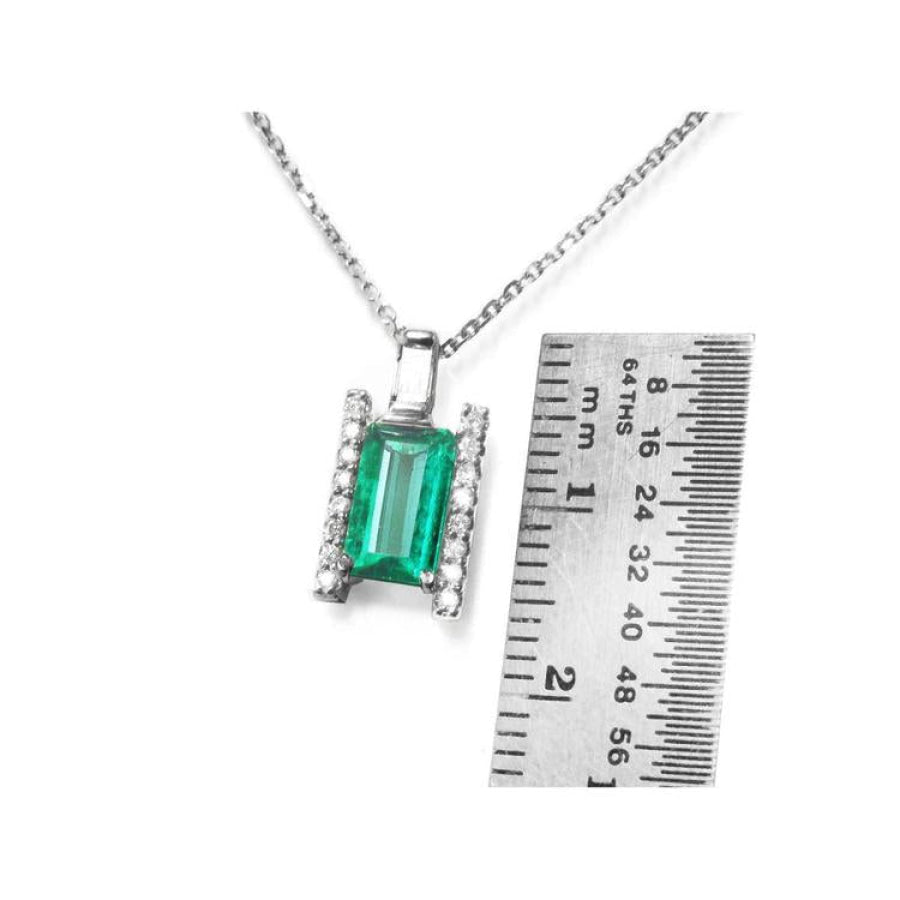 0.75 ct. baguette cut emerald and diamond pendant necklace in 14K white gold with ruler.