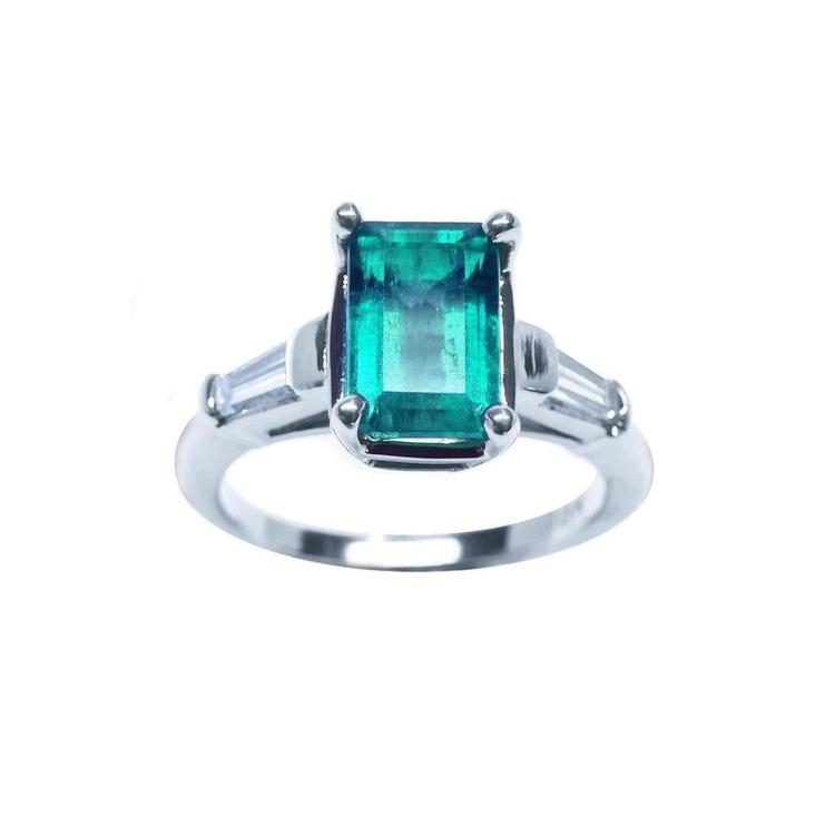 Natural colombian emerald and baguette side diamond ring for women crafted in 18 white gold.